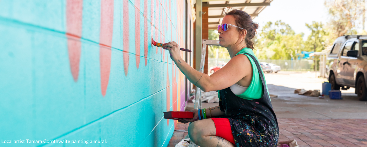 Local artist Tamara Cornthwaite painting a mural.